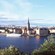 A ship docked alongside the Stockholm skyline